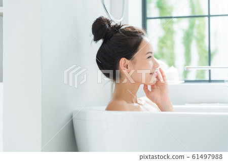 A woman taking a bath 61497988