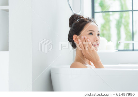 A woman taking a bath 61497990