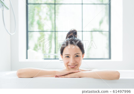 A woman taking a bath 61497996