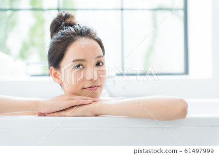 A woman taking a bath 61497999