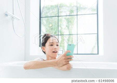 A woman taking a bath A woman taking a bath 61498006