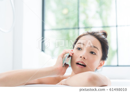 A woman taking a bath 61498010