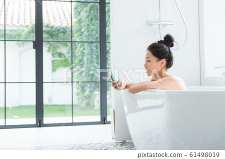 A woman taking a bath 61498019