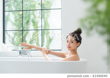 A woman taking a bath 61498040