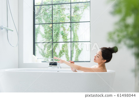 A woman taking a bath 61498044