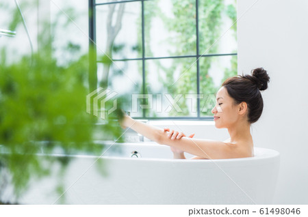 A woman taking a bath A woman taking a bath 61498046