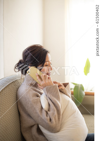 Young woman making a phone call with smartphone Young woman making a phone call with smartphone 61500402