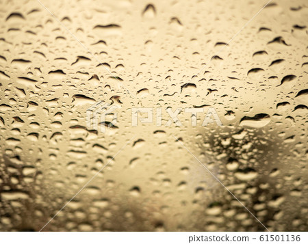 Close up view of water drops falling on glass Close up view of water drops falling on glass 61501136