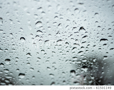 Close up view of water drops falling on glass Close up view of water drops falling on glass 61501149