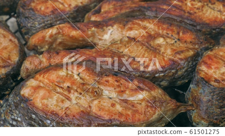 Fried grilled salmon on bbq. Marinade from white sauce and lemon. Fried grilled salmon on bbq. Marinade from white sauce and lemon. 61501275