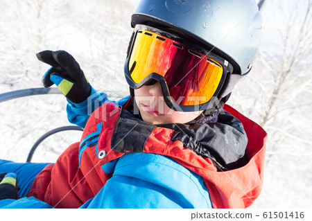 Kids riding a ski lift Kids riding a ski lift 61501416
