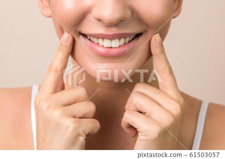 lip protection. closeup of a young woman beautiful smile, healthy lips and white teeth in high resolution 61503057