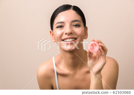 lips care and protection. smiling beautiful woman holding lip balm lips care and protection. smiling beautiful woman holding lip balm 61503060