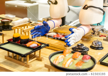Sushi maker robots are serving food in future genius restaurants. 61503193