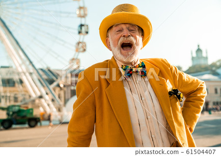 Funny elderly man laughing in the city 61504407