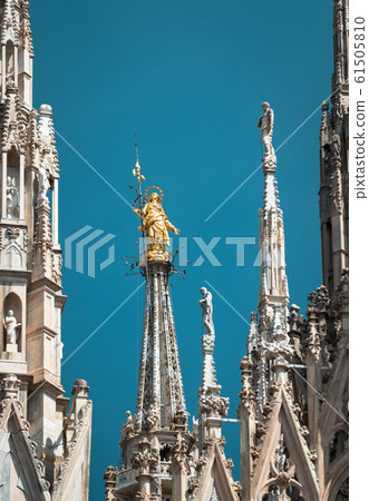 Milan Cathedral spires, Italy. Golden statue of 61505810