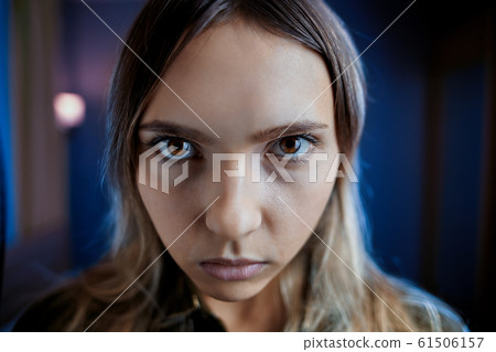 Offended jealous woman on a dark background. Offended jealous woman on a dark background. 61506157