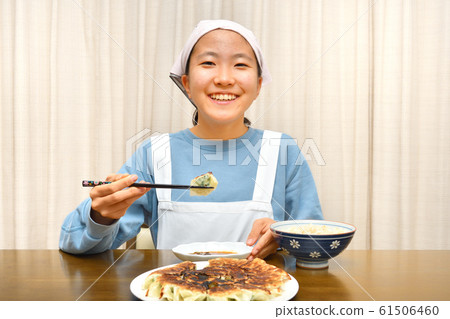 Girls eating dumplings Girls eating dumplings 61506460