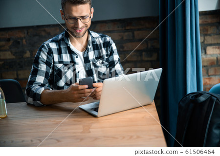 Attractive Caucasian male sitting in co-working space Attractive Caucasian male sitting in co-working space 61506464