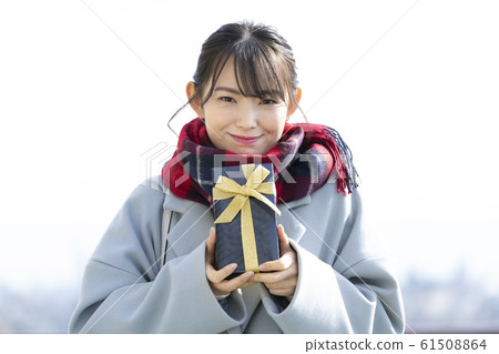 A young lady with a present A young lady with a present 61508864