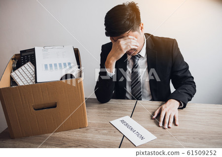 Male employee was sad at his desk when he received Male employee was sad at his desk when he received 61509252