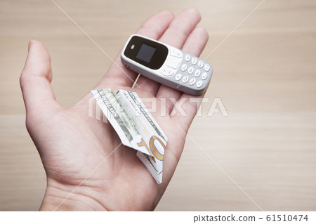 mobile phone money hand table background mobile phone money hand table background 61510474