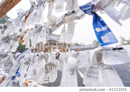 Saga, Japan - Nov. 12, 2018: Japanese random fortune telling paper (Omikuji) folded and tied on rope wires (Omikuji kake) in traditional temple, concept of bringing blessing. 61511035