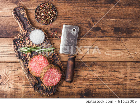 Fresh raw minced pepper beef burgers on vintage Fresh raw minced pepper beef burgers on vintage 61512009