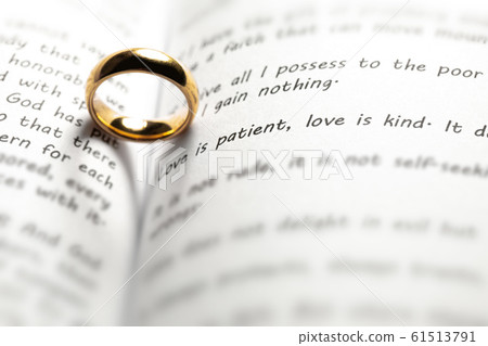 Golden wedding ring on bible book Golden wedding ring on bible book 61513791