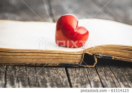 Love concept. Heart on open vintage book. Love concept. Heart on open vintage book. 61514123