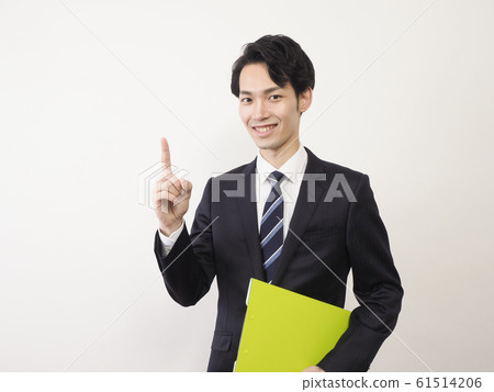 Business man with finger up and smiling 61514206