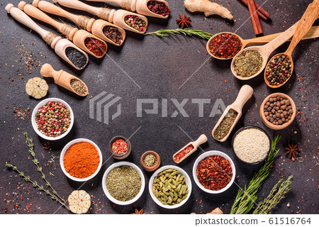 Spices and herbs over black stone background 61516764