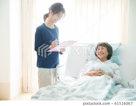 Senior woman and caregiver 61516867