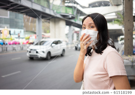 Woman wearing face mask protect filter against air 61518199