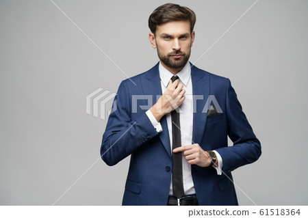 studio photo of young handsome stylish businessman wearing suit studio photo of young handsome stylish businessman wearing suit 61518364
