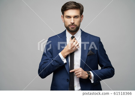 studio photo of young handsome stylish businessman wearing suit studio photo of young handsome stylish businessman wearing suit 61518366