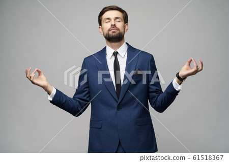 studio photo of meditative young handsome stylish businessman wearing suit studio photo of meditative young handsome stylish businessman wearing suit 61518367