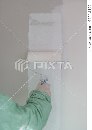 Roller painting white wall, ceiling with white paint Roller painting white wall, ceiling with white paint 61518592