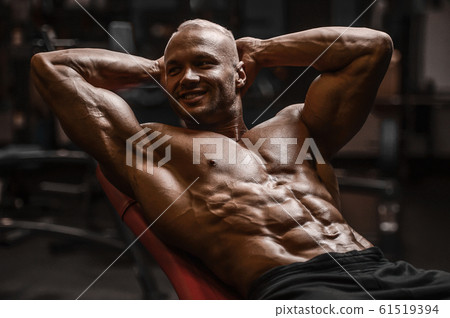 Handsome strong athletic men pumping up muscles Handsome strong athletic men pumping up muscles 61519394