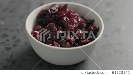 closeup dried cranberry in white bowl on terrazzo countertop 61520143