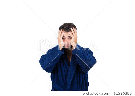 Portrait of tardy young man wears blue bathrobe Portrait of tardy young man wears blue bathrobe 61520396