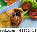 Snapper topped with sauce 61522414