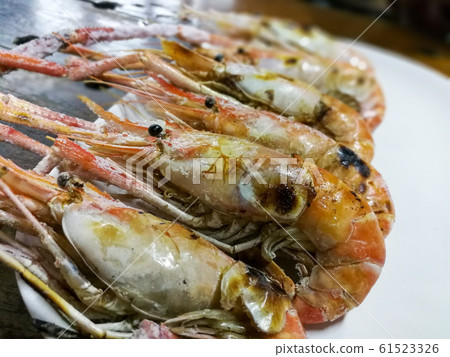 Grilled shrimp on a white plate Popular food in Thailand Grilled shrimp on a white plate Popular food in Thailand 61523326