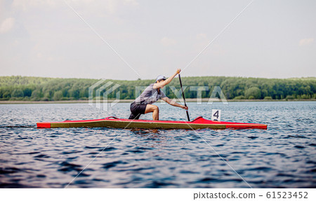 young athlete canoeist rowing 61523452