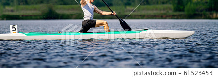 athlete canoeist rowing in canoe 61523453