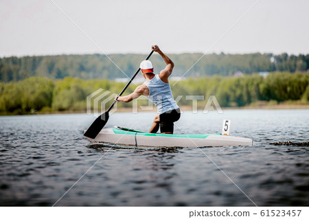athlete canoeist rowing in lake 61523457