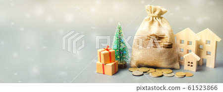 Money bag, wooden houses, Christmas tree and gifts. Christmas Sale of Real Estate. New Year discounts for buying housing. Purchase apartments at a low price. Holiday discounts. Favorable prices Banner Money bag, wooden houses, Christmas tree and gifts. Christmas Sale of Real Estate. New Year discounts for buying housing. Purchase apartments at a low price. Holiday discounts. Favorable prices Banner 61523866