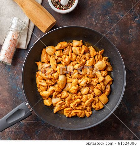 Chicken fillet cut into small pieces for frying in 61524396