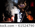 worker welds metal structures by electric arc 61524790