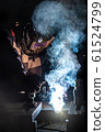 worker welds metal structures by electric arc 61524799